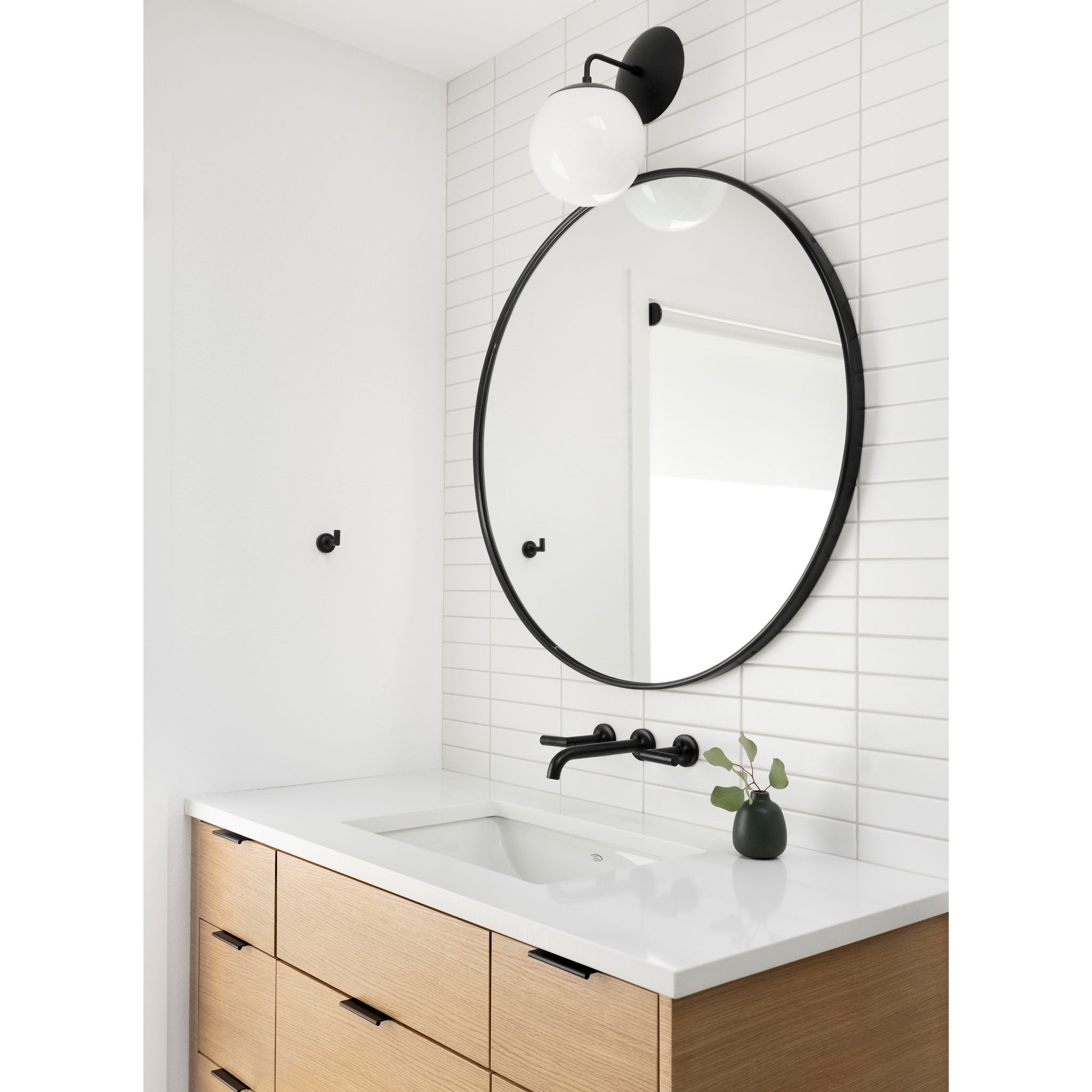 Alto 8" Sconce in Matte Black with an opal globe. Interior Design by Anna West Interiors. Photo by Meagan Larsen Photography