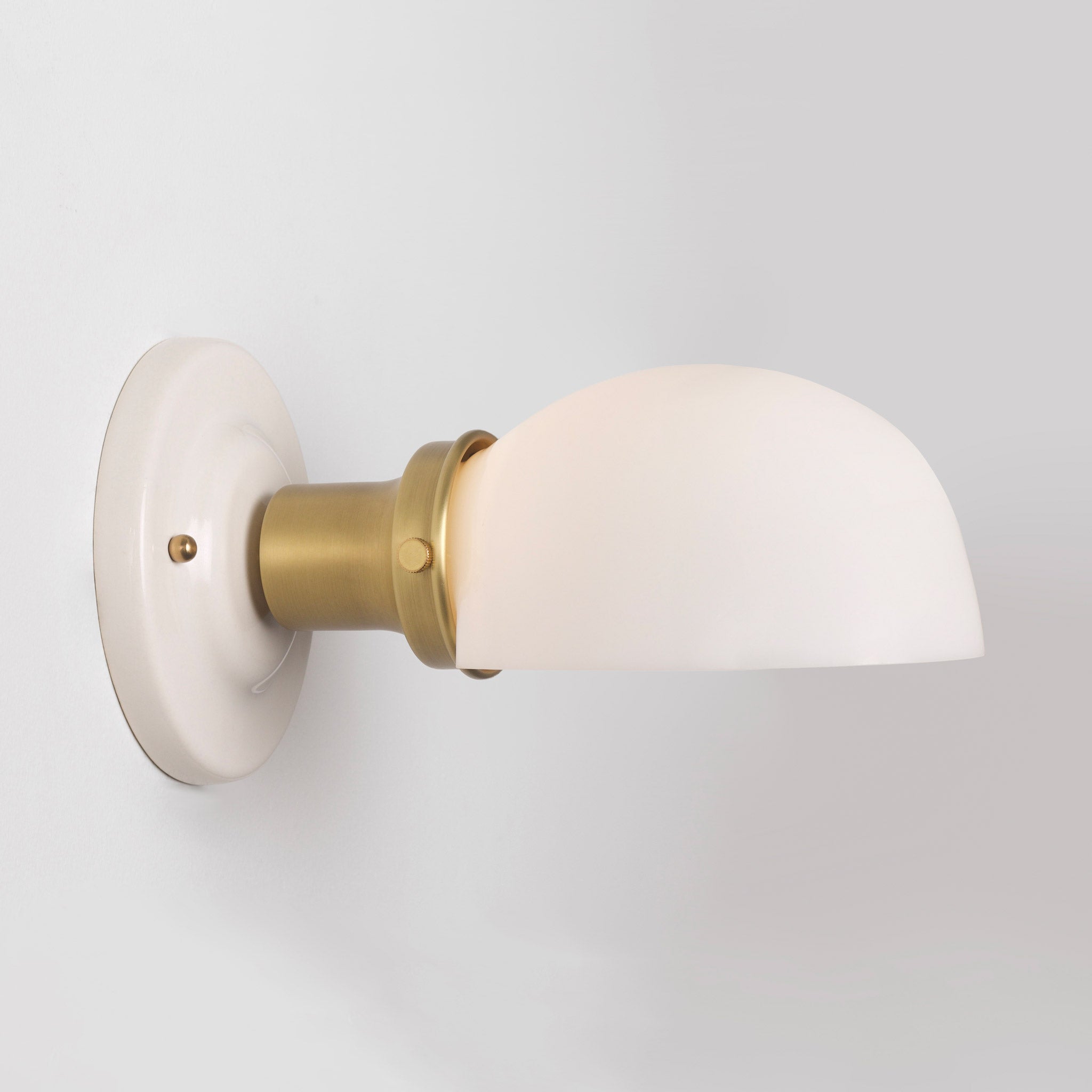 Archie Single shown in Heirloom Brass with a Gloss White Ceramic Canopy