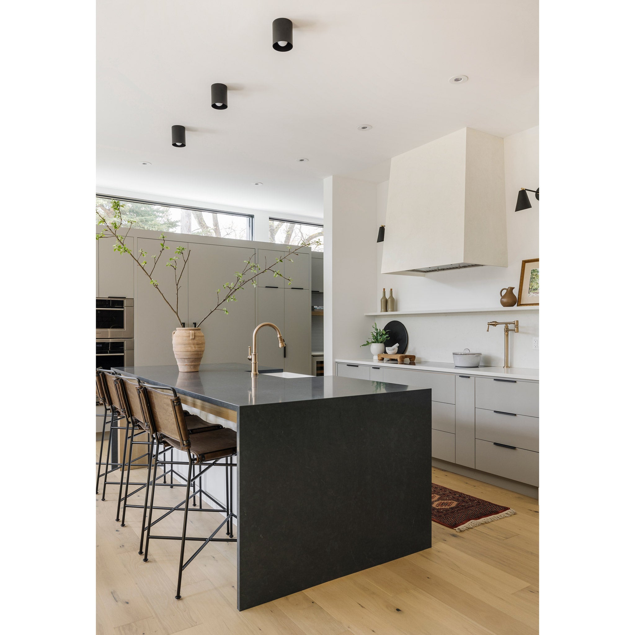 Cape Longs and Tilt Cone Sconces in Matte Black. Interior design by Alykhan Velji Designs