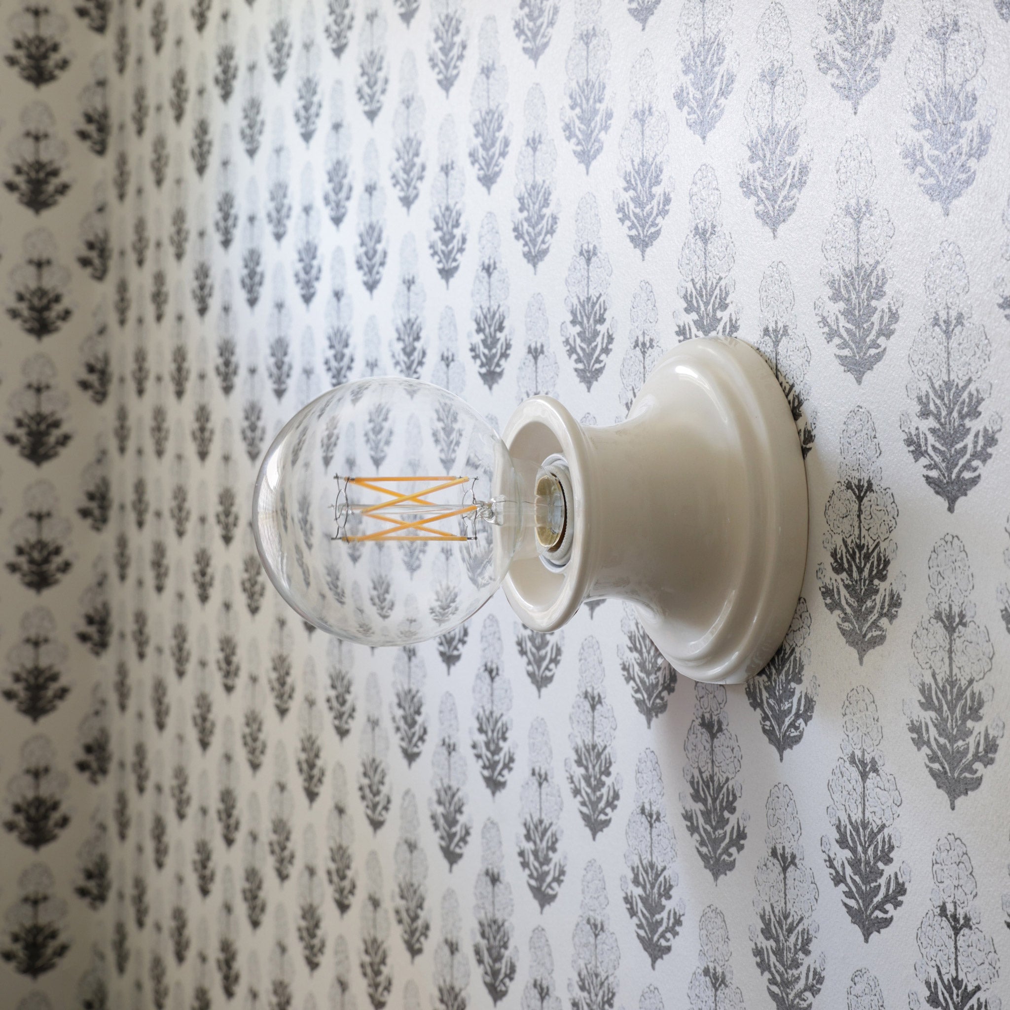 Emma Petite shown in Gloss White Glaze with Marigold wallpaper from Filling Spaces