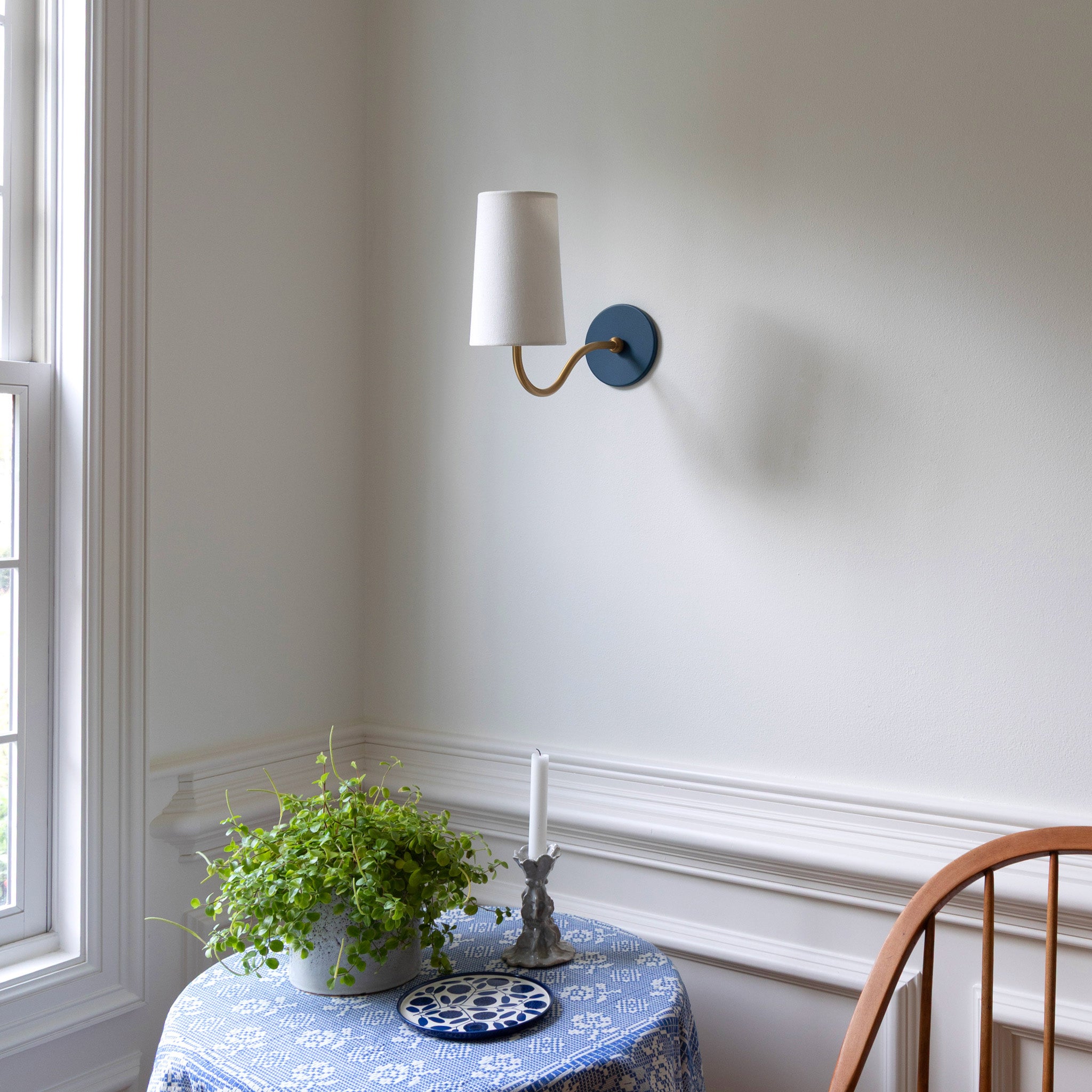 Genevieve Sconce shown in Heirloom Brass with an Ocean Blue canopy