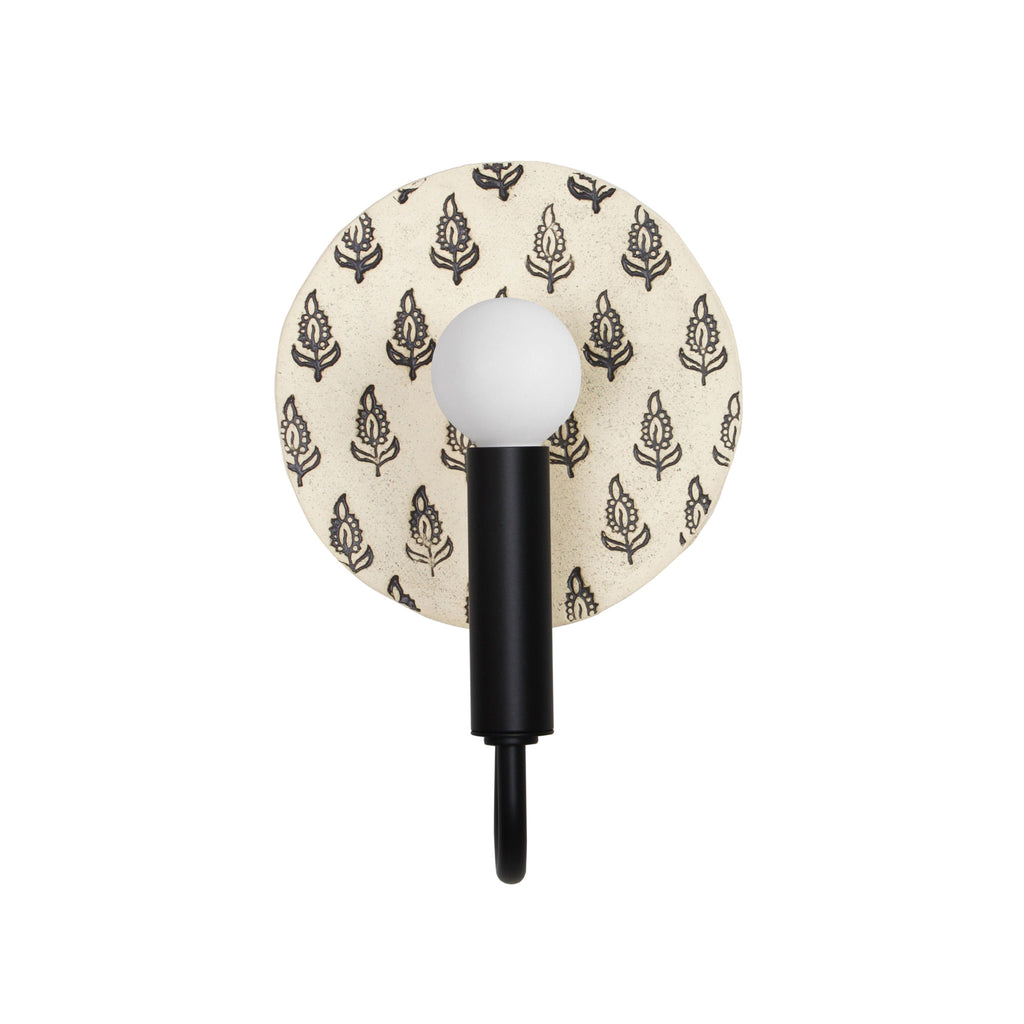 Edith ADA Sconce shown in Matte Black with a Black and Cream Floral ceramic backplate.