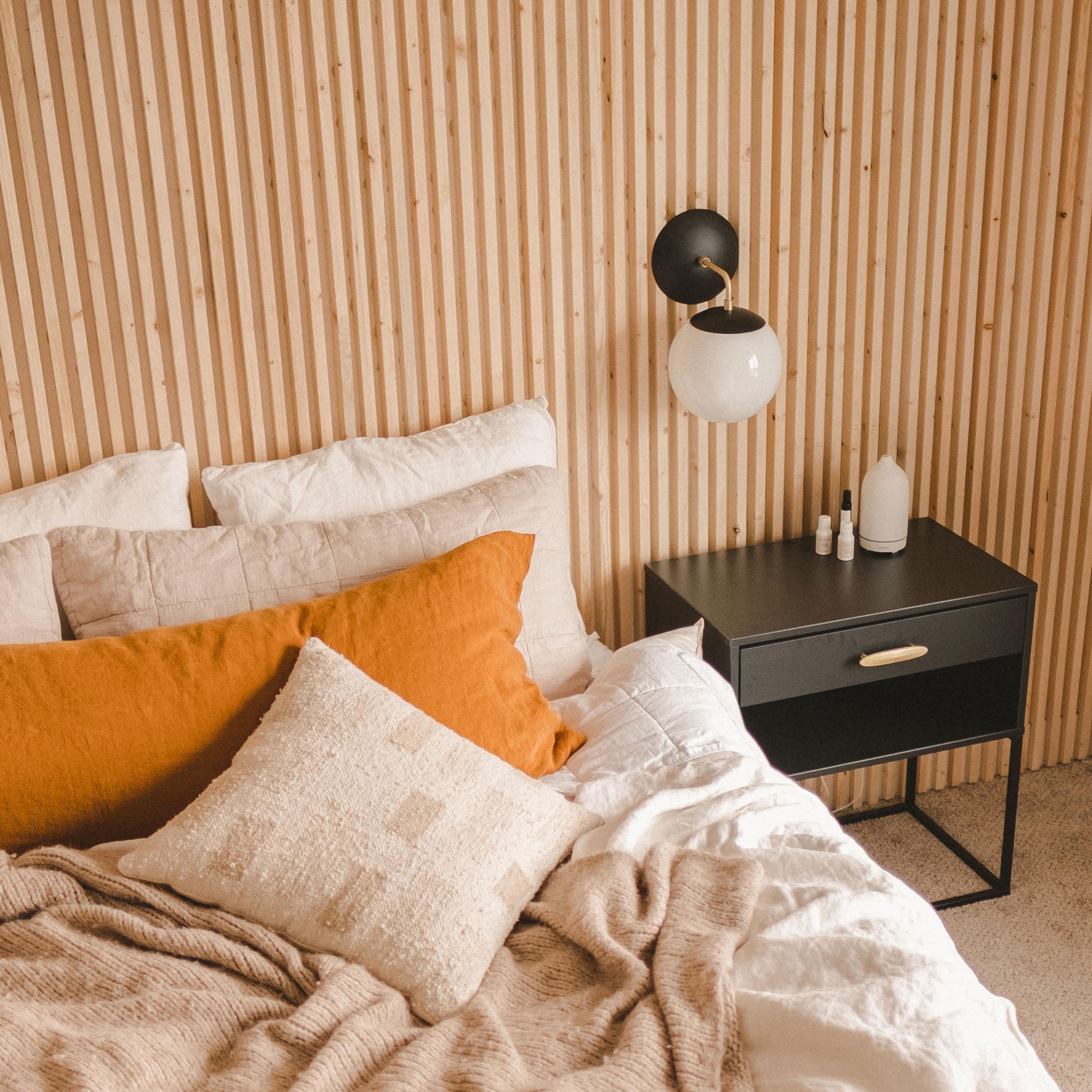 Alto Sconce 8" shown in Matte Black with Brass with an 8" Opal globe. Interior Design and Photo by Alivia Fields