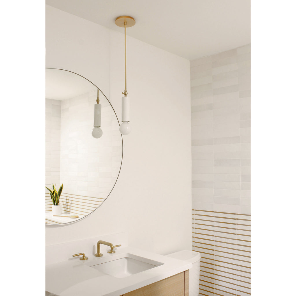 Fjord Spot Pendant shown in White with Brass with Standard Socket Placement. Interior design by Teal Davison.