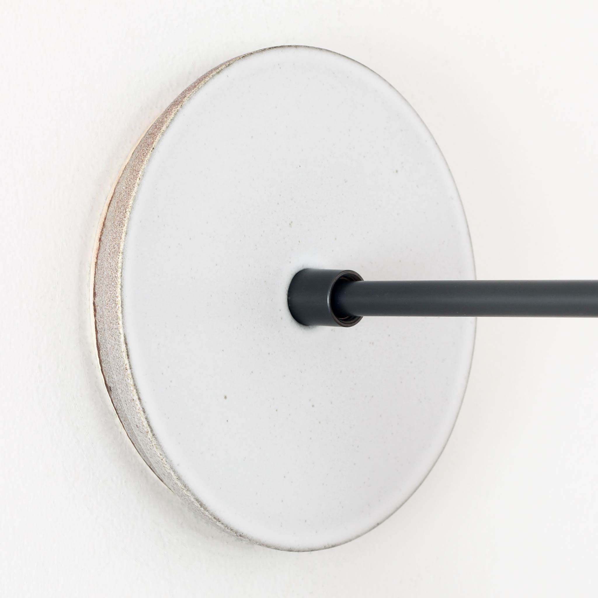 Swift canopy pattern shown in Brownstone White Ceramic with a Graphite Patina arm