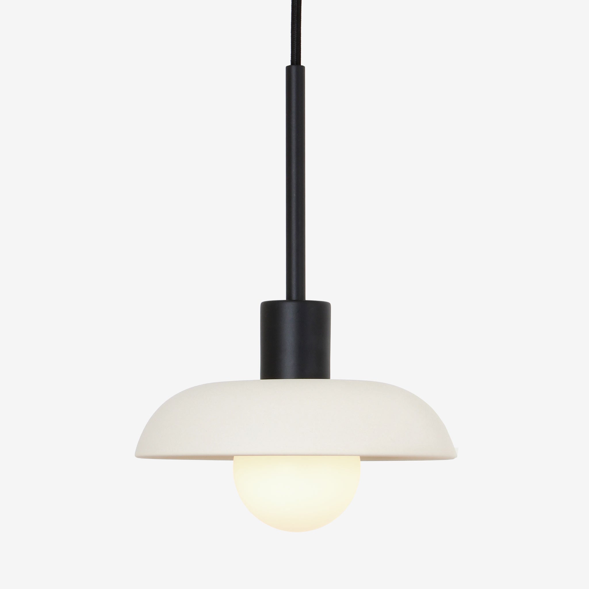 Terra Cord Pendant shown in Bone ceramic finish with Matte Black metal