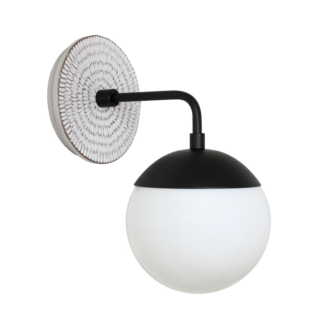 Alto Sconce 6" with Ceramic Canopy shown in Matte Black with a Brownstone White Sunflower Canopy Pattern and an Opal 6" globe.