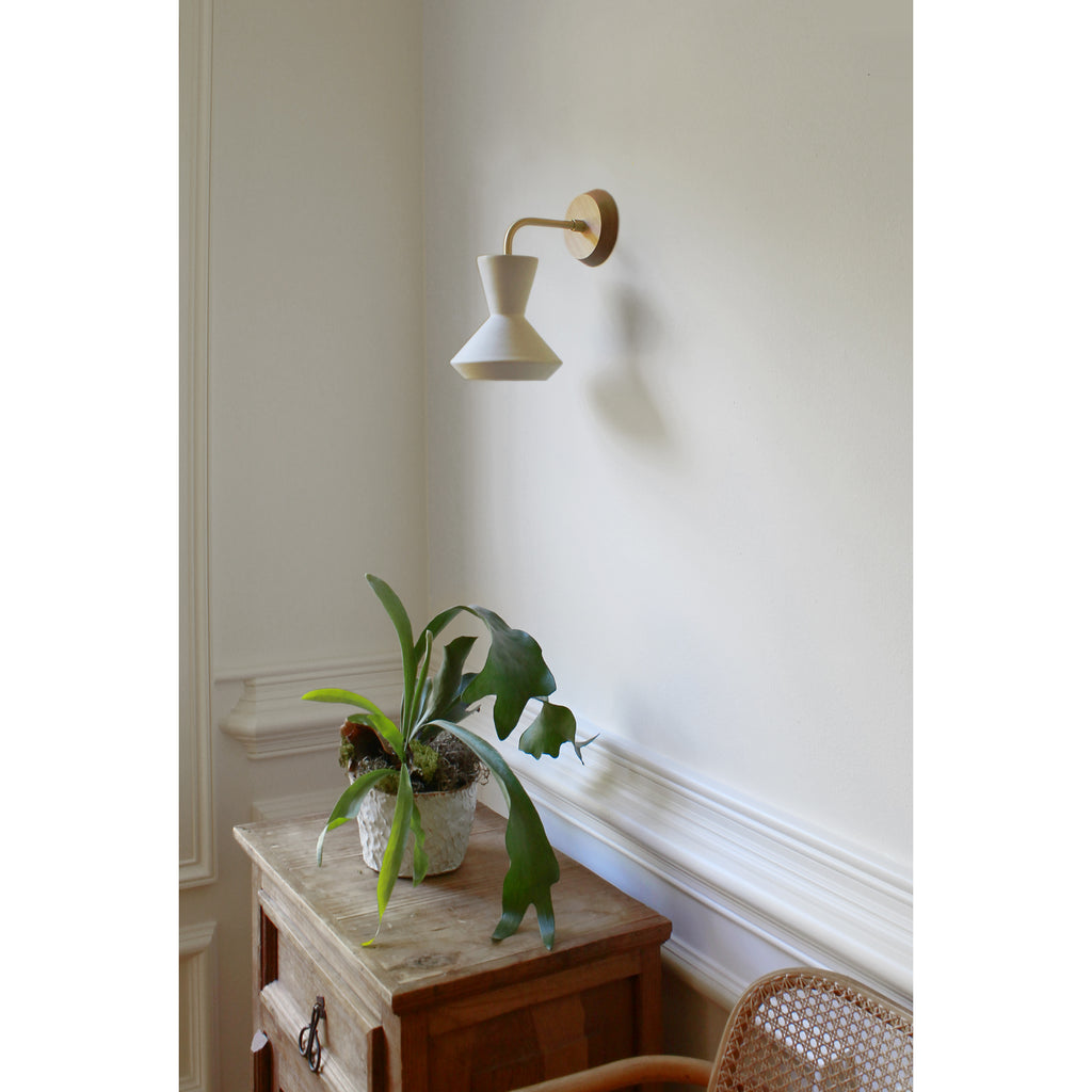 Bobbie Sconce shown in Natural White Glaze with Brass Metal and Maple Canopy. 