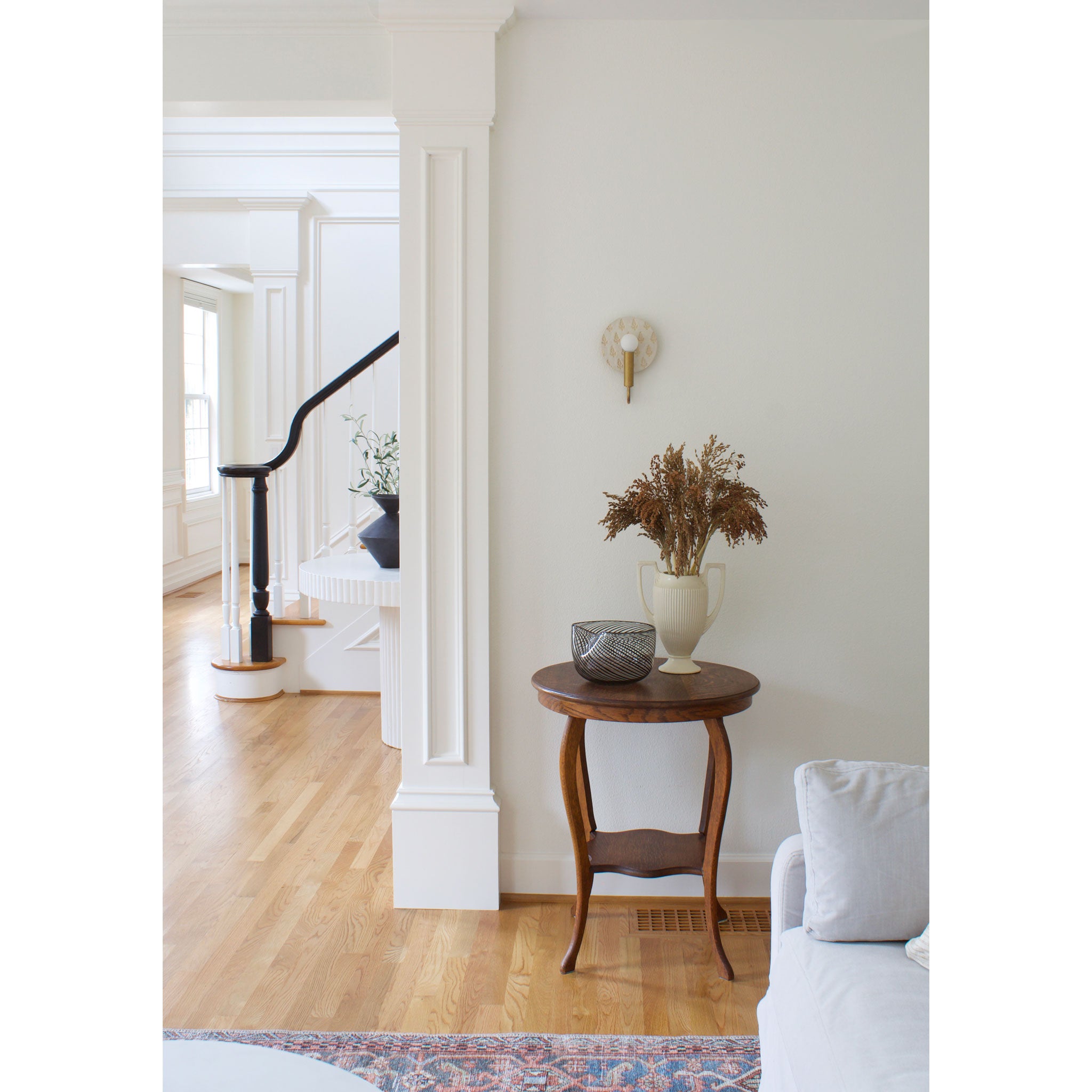 Edith ADA Sconce shown in Heirloom Brass with Natural White and Cream Floral Ceramic