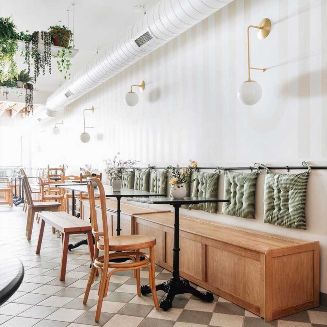 Ramona 8" Wall Sconce shown in Brass with an Opal 8" Glass Globe. Interior Design by Sarah Sherman Samuel