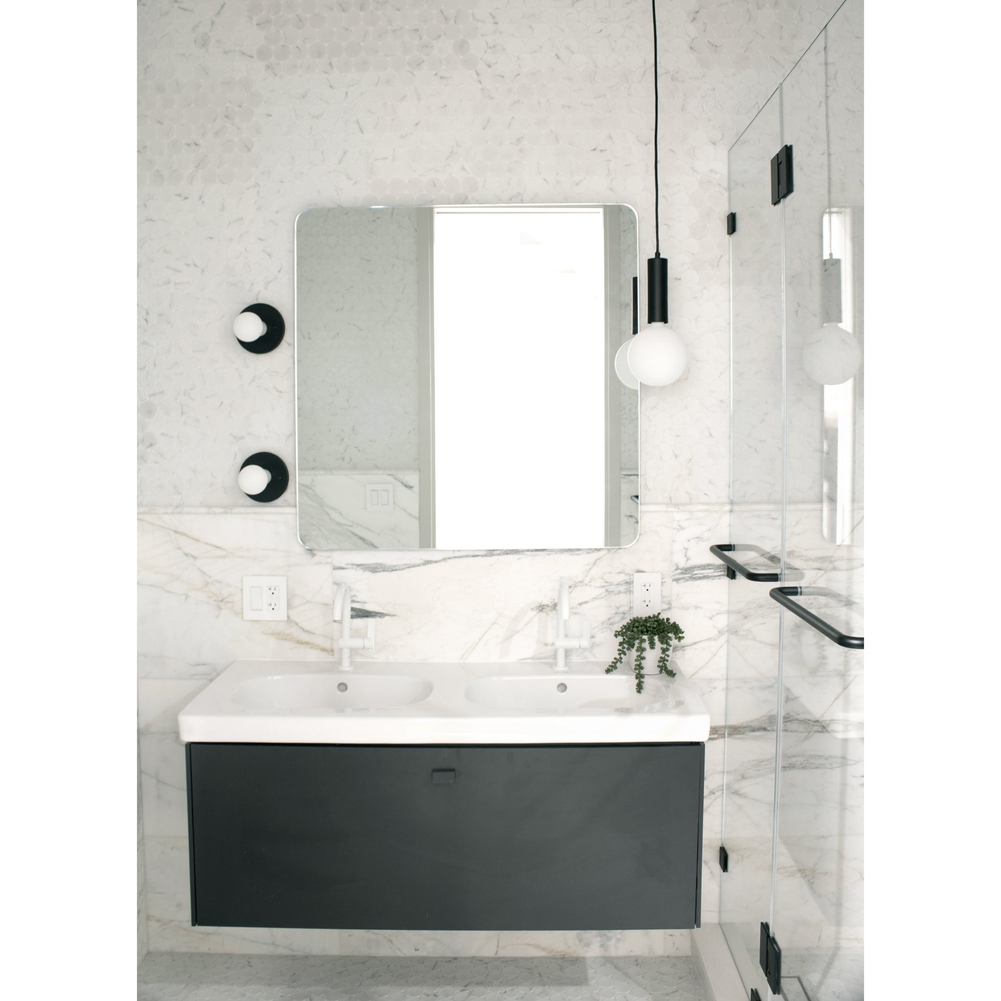 Fjord Cord Pendant shown in Matte Black with Black Cloth Cord. Swift Sconces shown in Matte Black