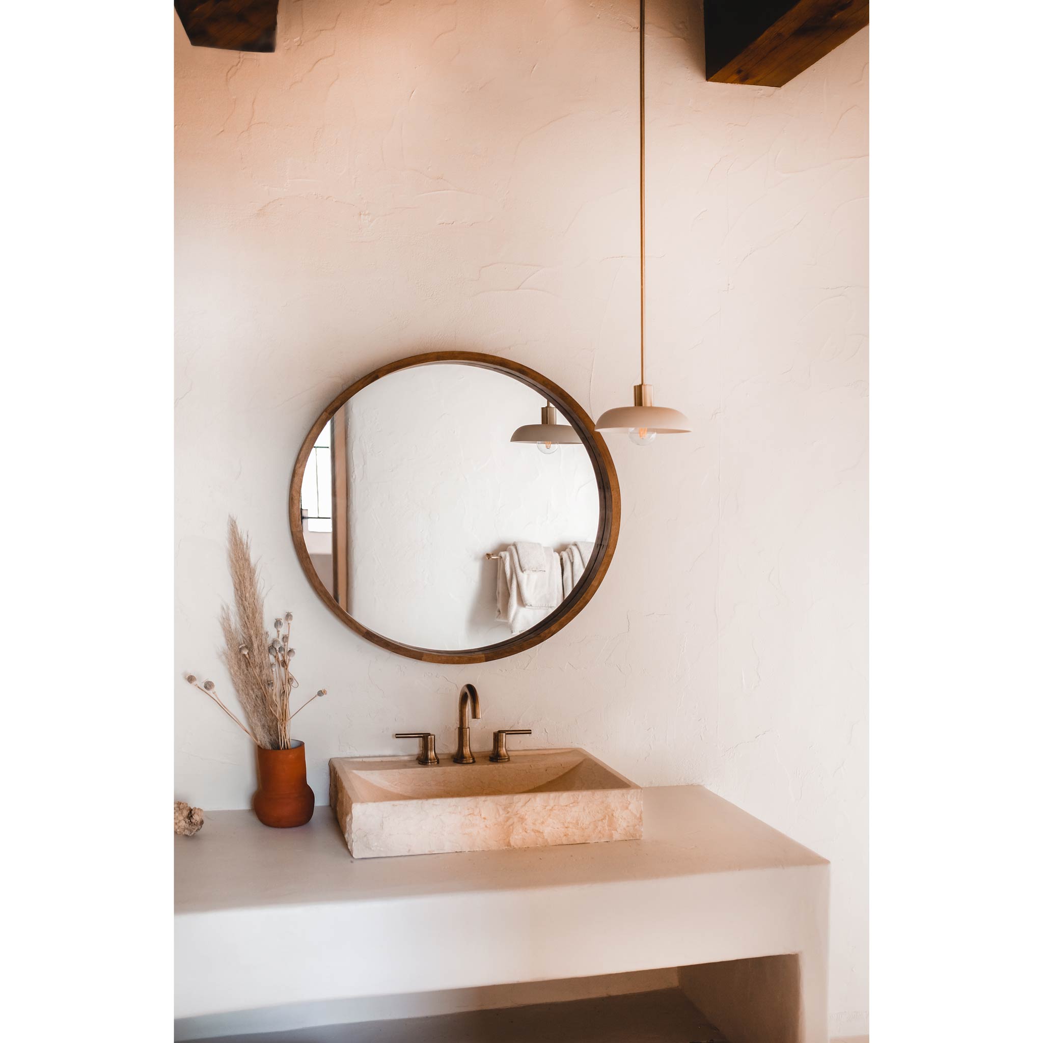 Terra Pendant shown in Bone ceramic finish with Brass metal. Interior Design by The Joshua Tree House