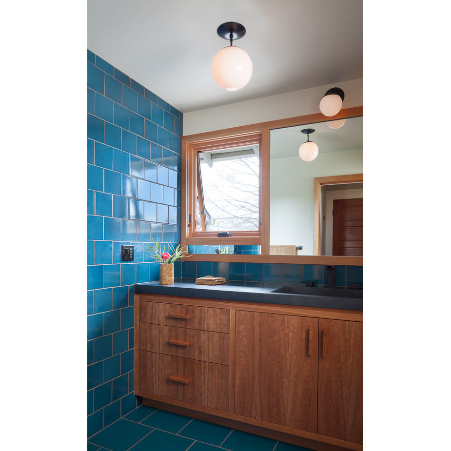 Alto Surface 10" for Vaulted Ceiling shown in Graphite Patina with an Opal 10" globe. Interior Design by Howells Architecture and Design. Photo by Laurie Black