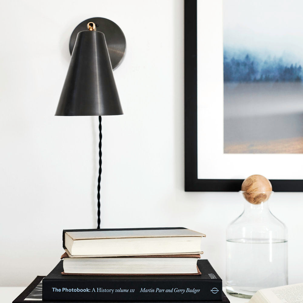 Tilt Cone shown in Graphite Patina and Brass with Black cord. Interior design and photo by Rachel Meadow