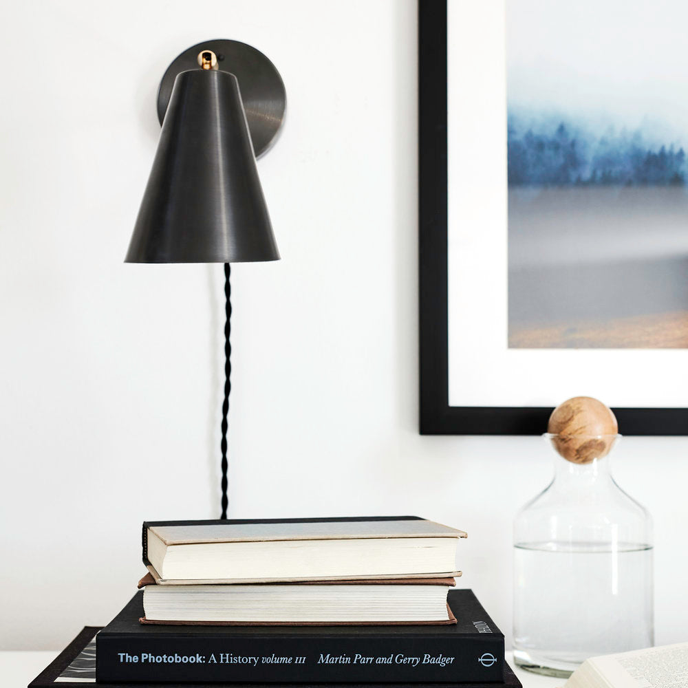 Tilt Cone shown in Matte Black with Brass with Black cord. Interior design and photo by Rachel Meadow.