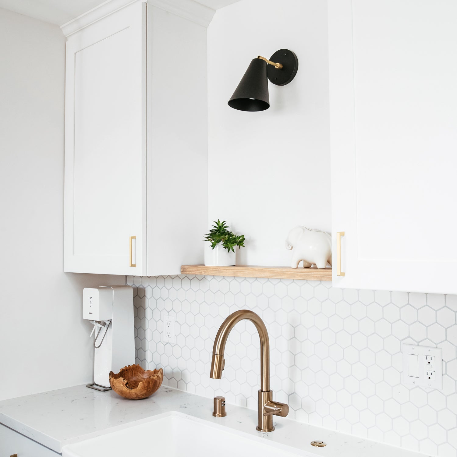 Tilt Cone shown in Matte Black and Brass with a 3" arm. Interior design by Field Theory Design. Photo by Ana Kamin