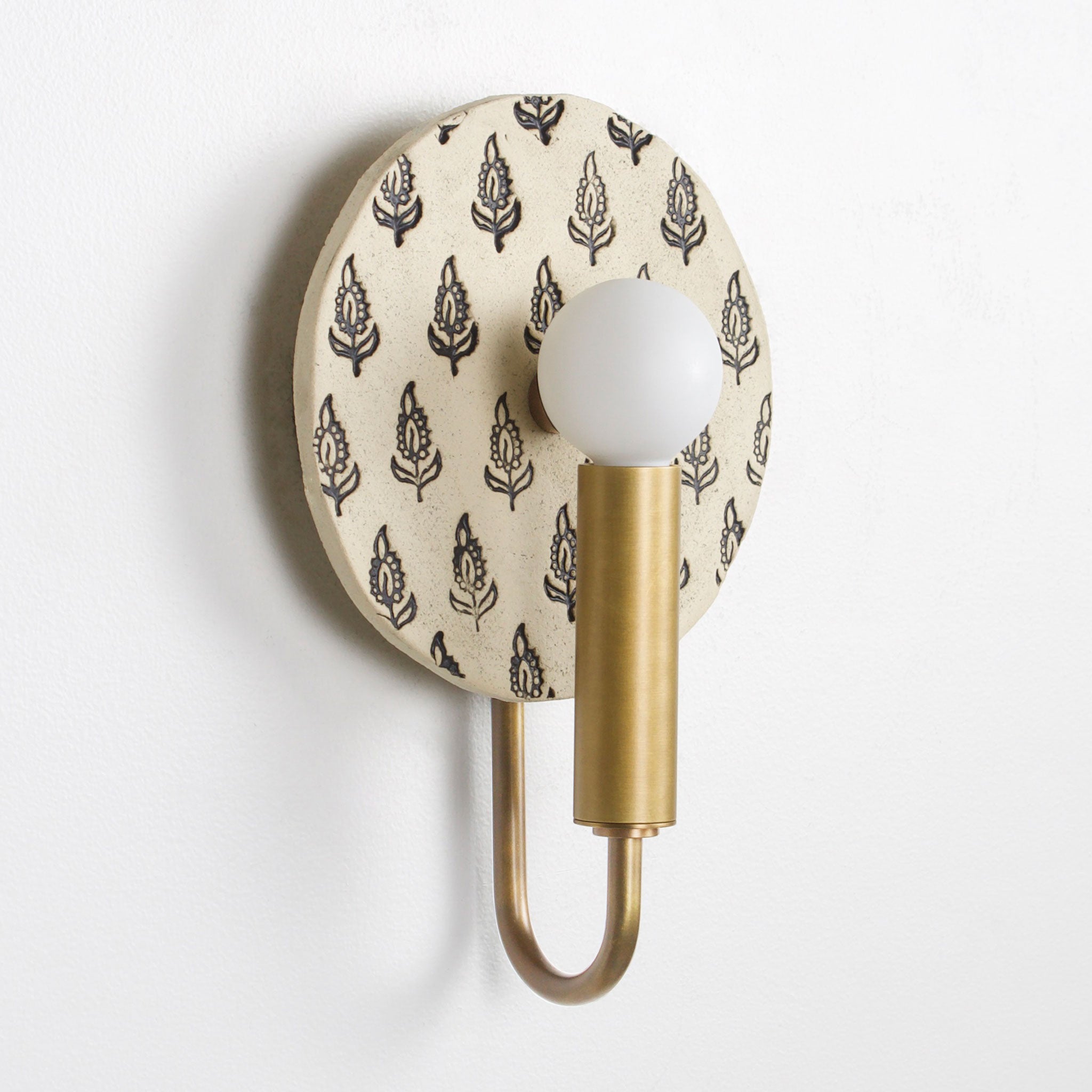 Edith ADA Sconce shown in Heirloom Brass with Black and Cream Floral Ceramic