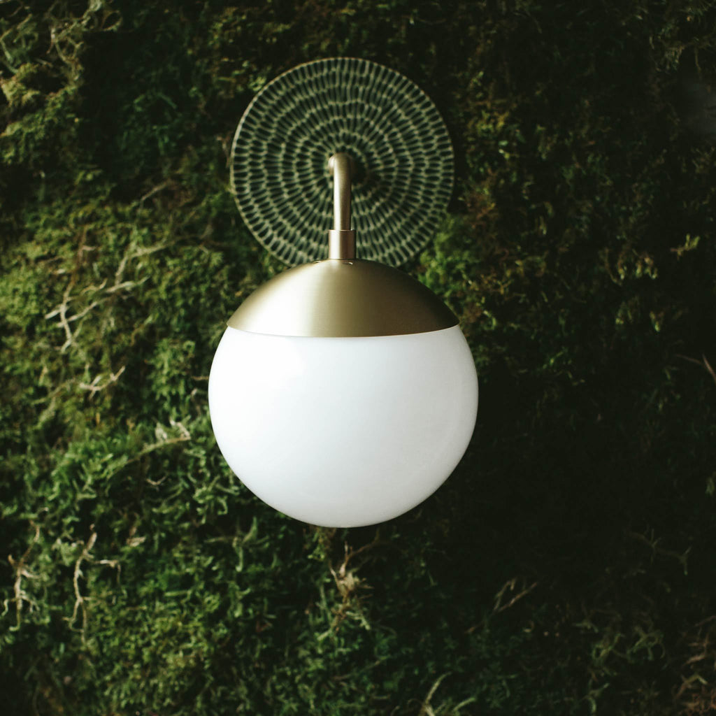 Alto Sconce 6" shown in Brass with Sunflower Canopy pattern in Forest Green Ceramic. Photo by Kris LeBoeuf.