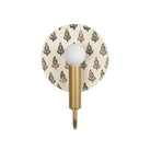 Edith ADA Sconce shown in Heirloom Brass with a Black and Cream Floral Ceramic Canopy