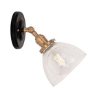 Grace Flush Sconce shown in Heirloom Brass with a Gloss Black Ceramic canopy and Clear Glass shade
