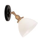 Grace Flush Sconce shown in Heirloom Brass with a Gloss Black Ceramic canopy and Opal Glass shade