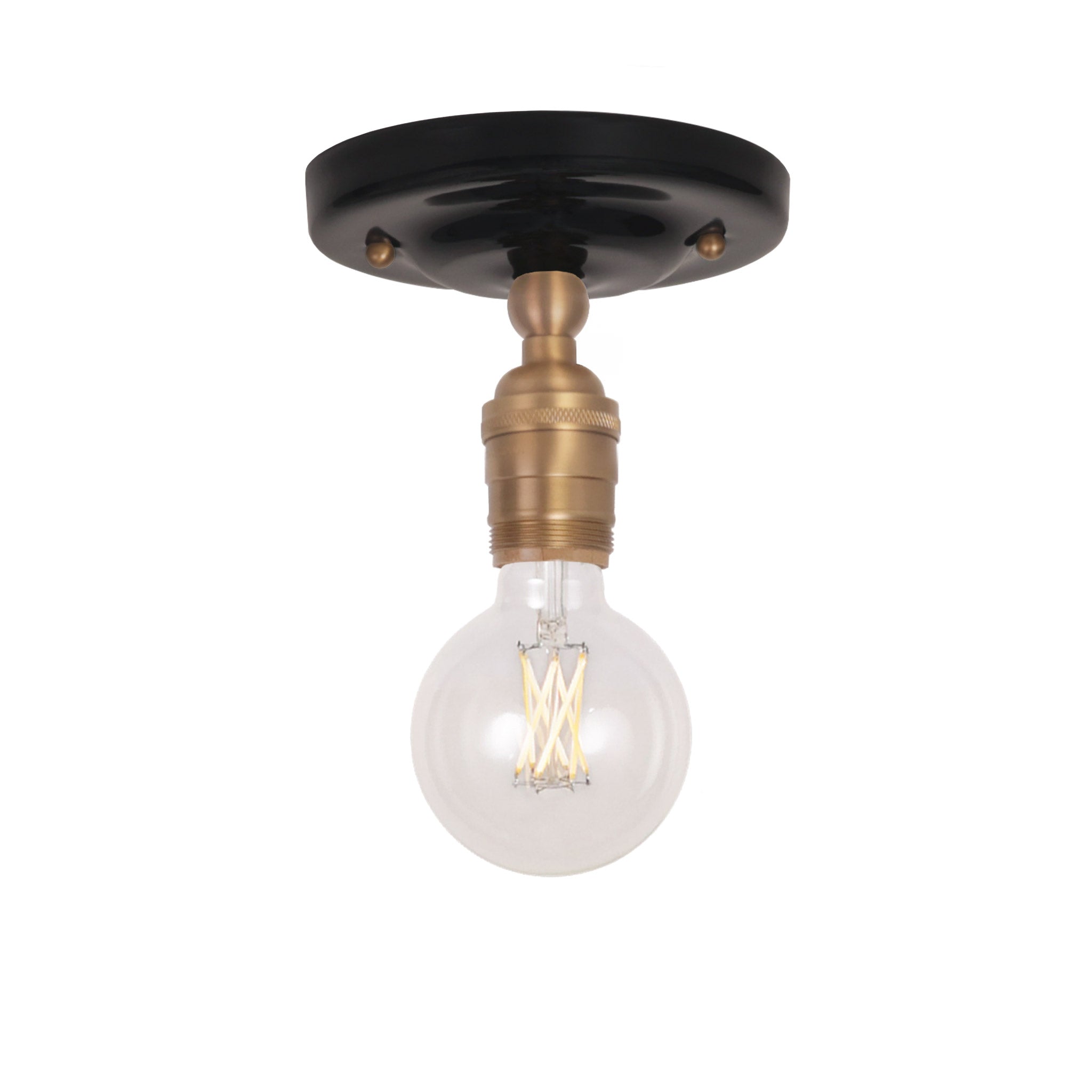 Grace Surface shown in Heirloom Brass with a Gloss Black Ceramic canopy and no shade