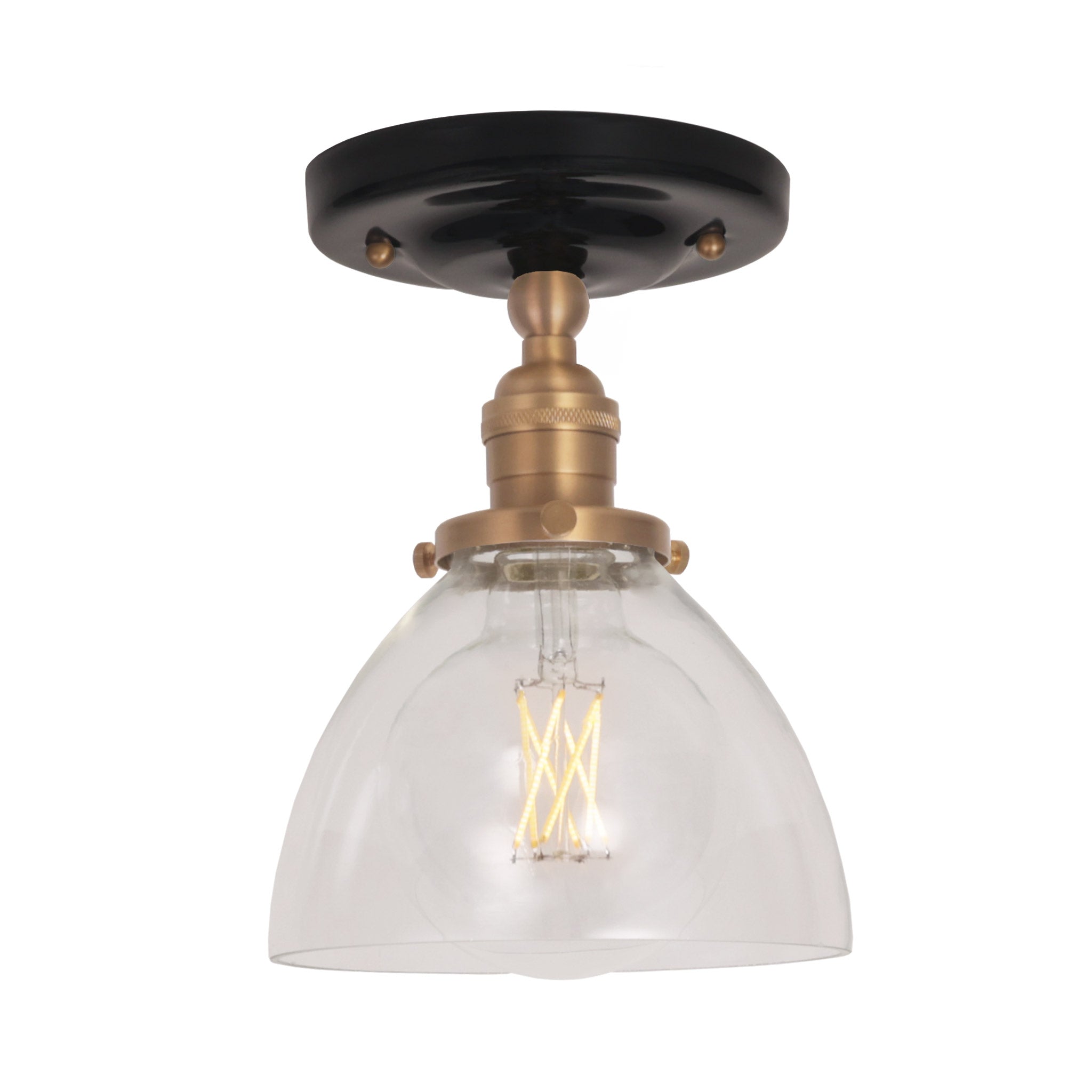 Grace Surface shown in Heirloom Brass with a Gloss Black Ceramic canopy and Clear Glass shade