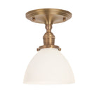 Grace Surface shown in Heirloom Brass with an Opal Glass shade