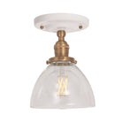 Grace Surface shown in Heirloom Brass with a Gloss White Ceramic canopy and Clear Glass shade