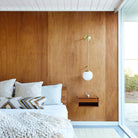 Ramona 8" wall sconce shown in Brass with an Opal 8" Glass Globe. Interior Design by Brett Foken of Decorotation. Photo by Margaret Austin Photo