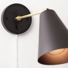 Tilt Cone shown in Matte Black and Brass with a 9" arm, Backplate Dimmer Switch and White Cord