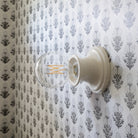 Emma Petite shown in Gloss White Glaze with Marigold wallpaper from Filling Spaces 
