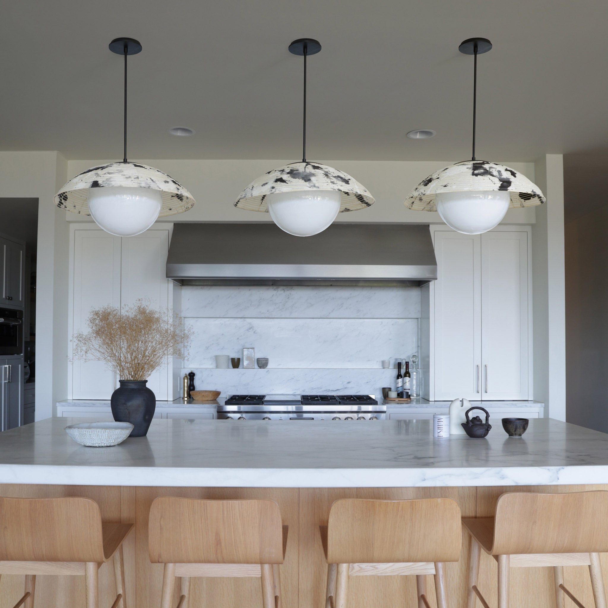 Maru Pendants with a Sumi Shades shown in Matte Black with a Black Stained Wood canopies