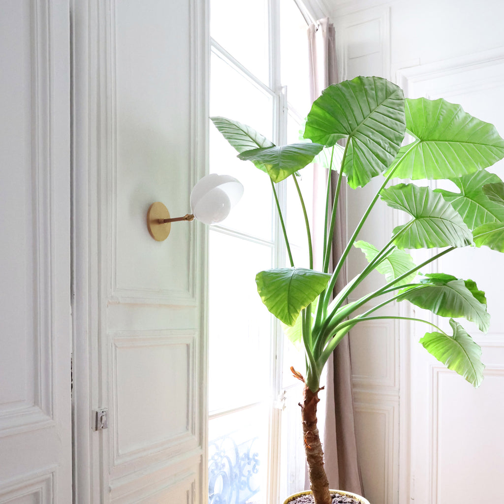 Noor Sconce shown in Heirloom Brass with a White Opal Acrylic Shade