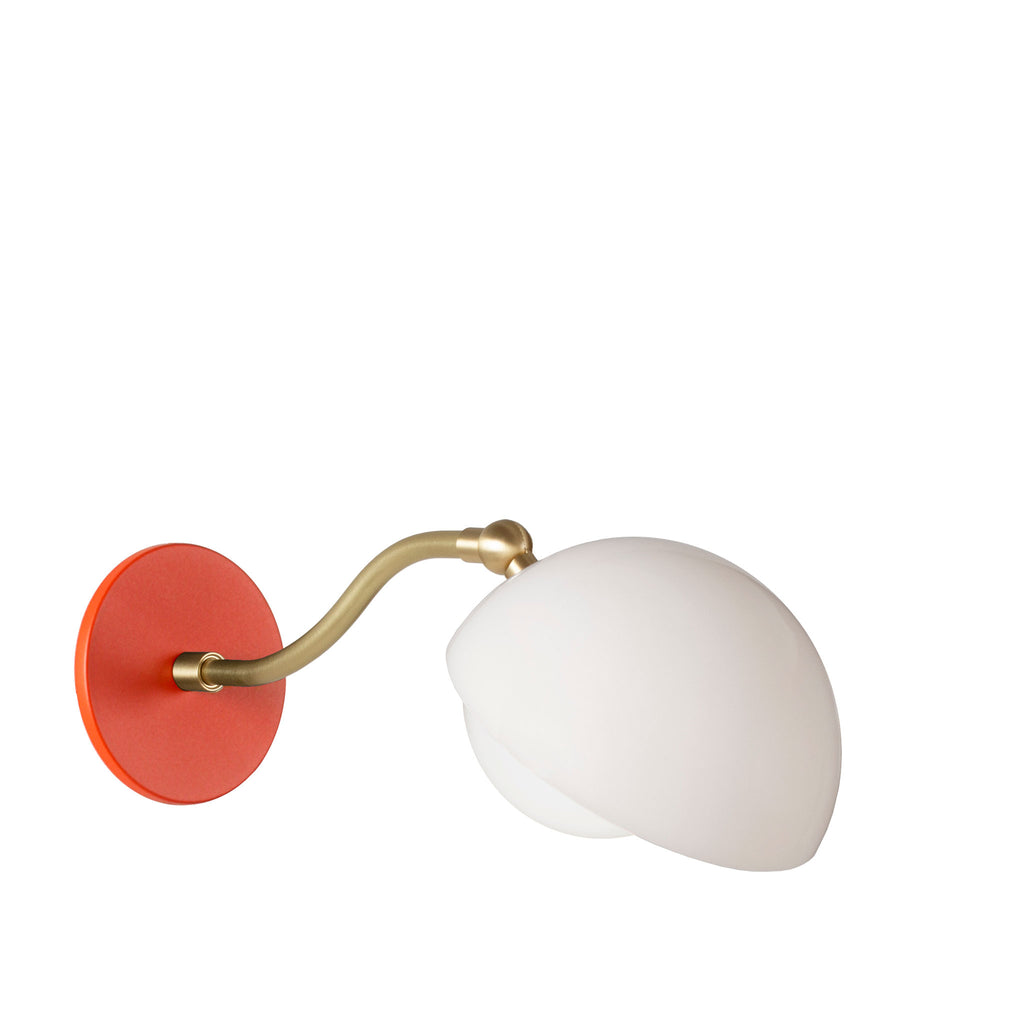 Noor Curve Sconce shown with a White Opal Acrylic Shade, Brass Arm, and Persimmon Canopy.