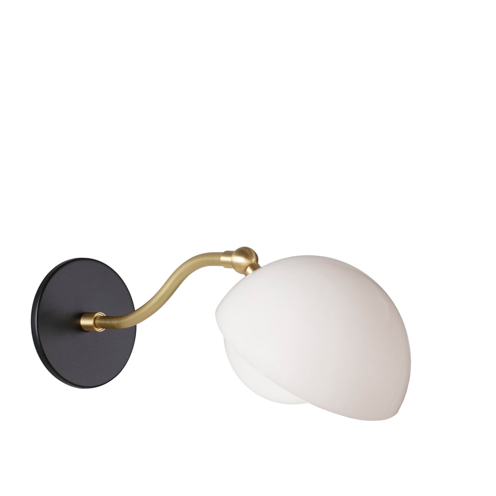 Noor Curve Sconce shown with a White Opal Acrylic Shade, Brass Arm and Matte Black Canopy.