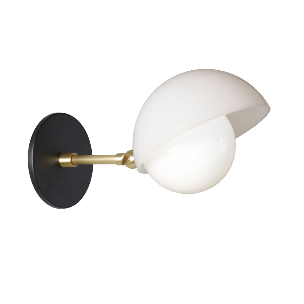 Noor Sconce shown with a White Opal Acrylic Shade, Brass Arm, and Matte Black Canopy.