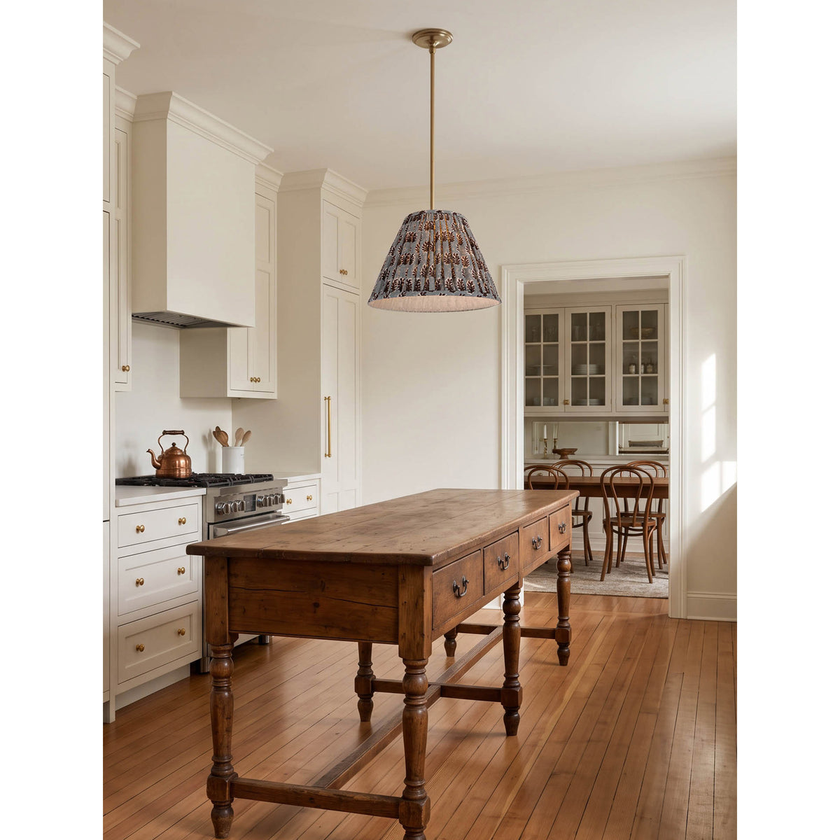 Oxford Pendant shown in Heirloom Brass with a Trulli Auburn Shade