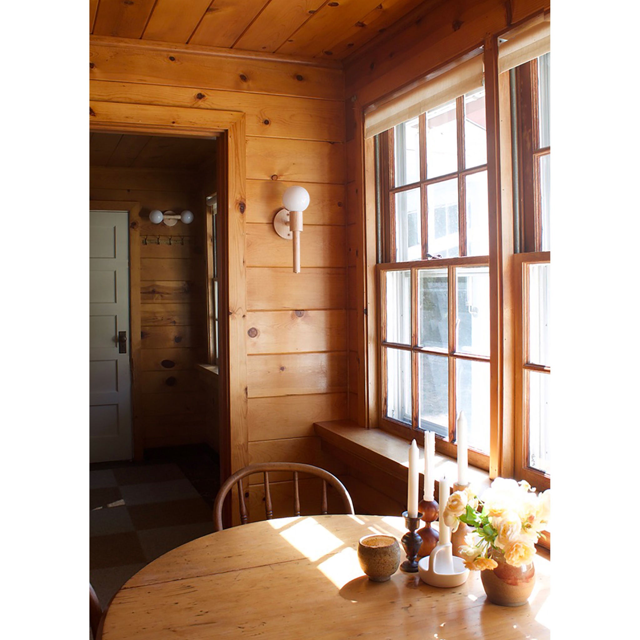 Parker Sconce shown in Maple. Rosie sconce in background