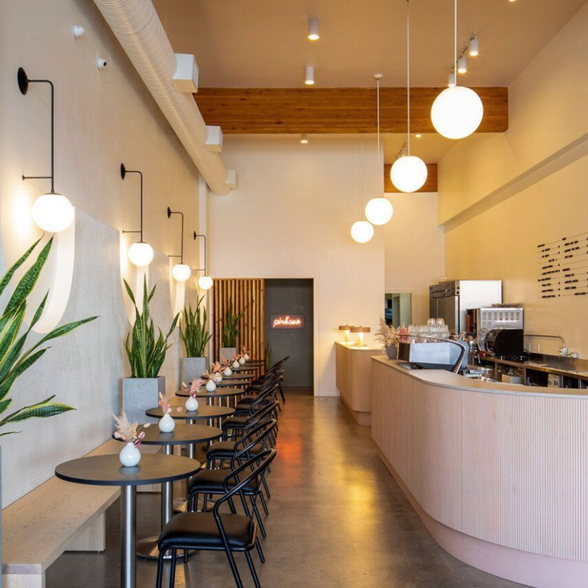 Ramona Sconces in matte black at Pinkavo Cafe designed by Studio Illa