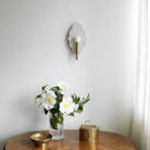 Clare Ceramic Sconce shown in Heirloom Brass with a Natural White Glaze 