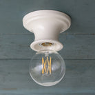 Emma Petite in Gloss White Glaze with a G30 LED Filament Light Bulb