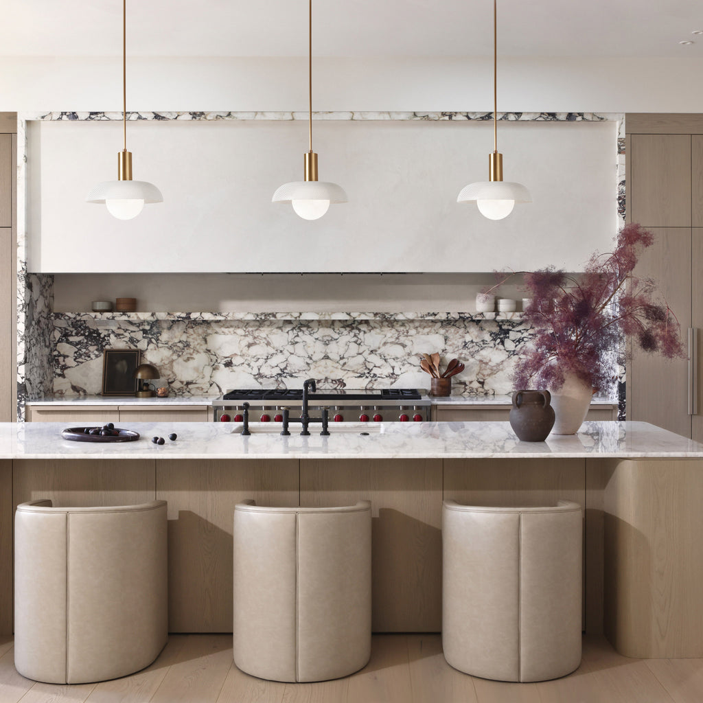 Lexi Large Pendant shown with White Perforated Shade Finish and Heirloom Brass Fixture Finish.