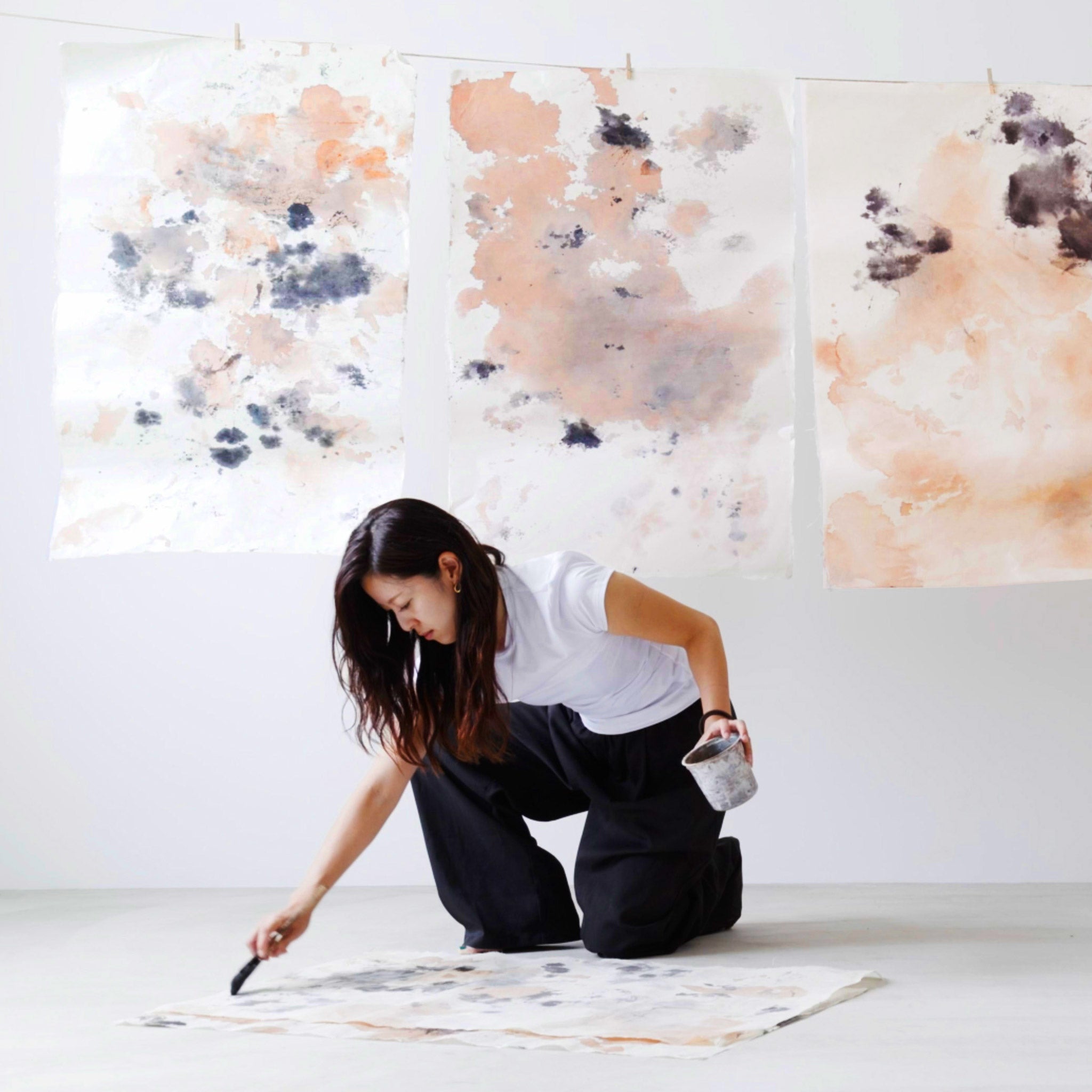 Japanese artisan hand-painting washi paper with sumi ink and kakishibu dye  