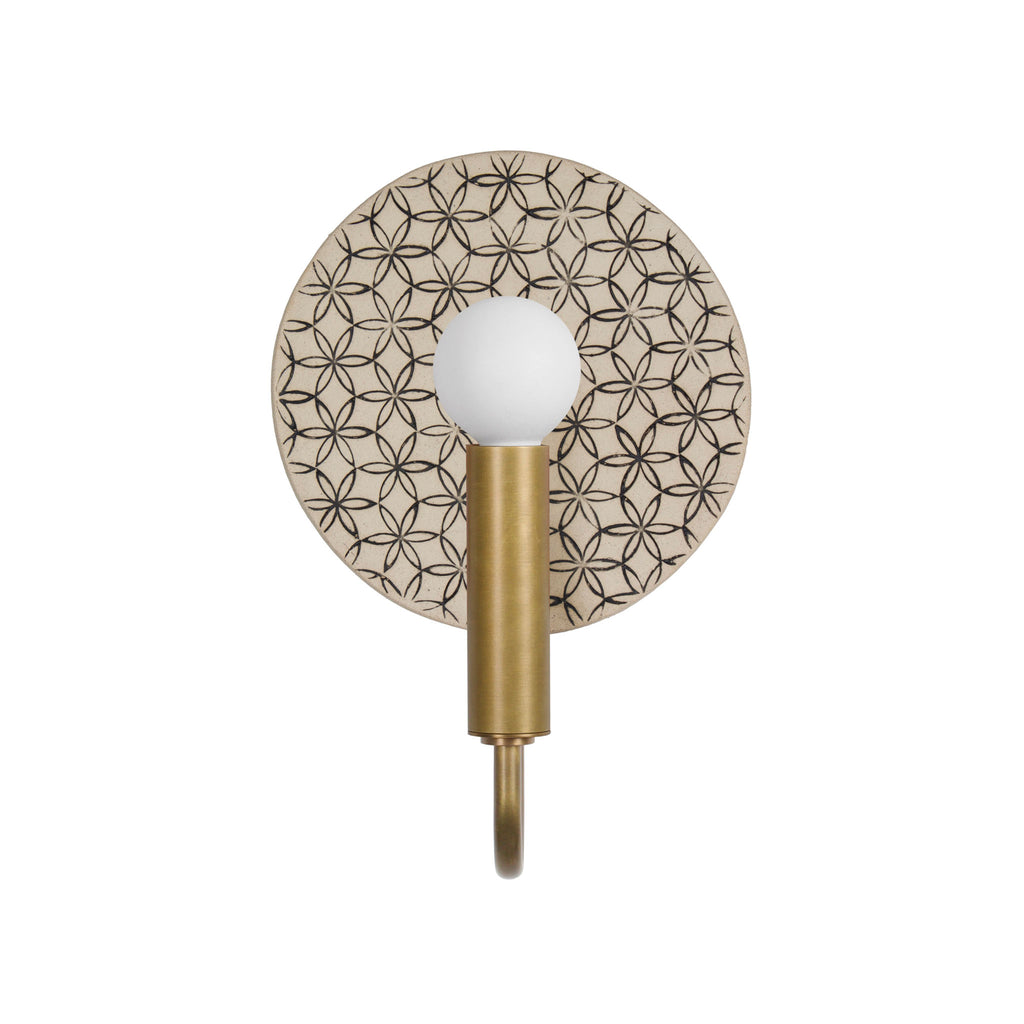 Edith ADA Sconce shown in Heirloom Brass with a Black and Cream Quilted ceramic backplate.