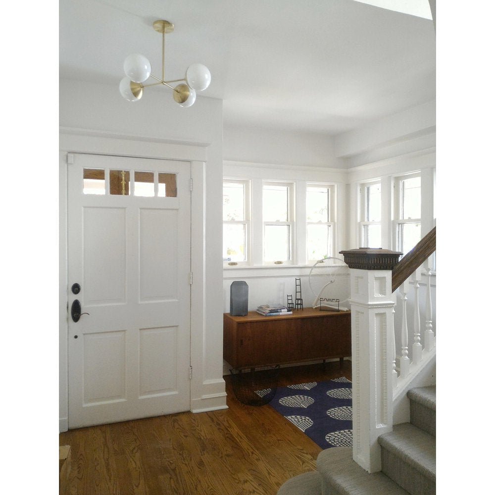 Alto Compass 6" Opal for Vaulted Ceiling shown in Brass. Interior Design by Cameron Macneil