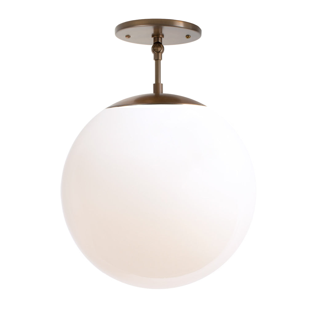 Alto Surface 12" for Vaulted Ceiling shown in Heirloom Brass with an Opal 12" Globe. 