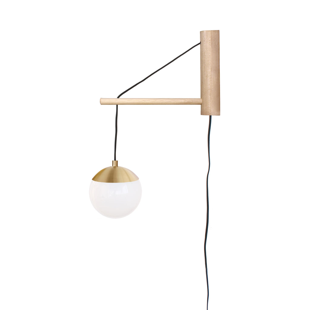 Alto 14" Wood Arm Sconce shown in Brass with Birch, a 6" Opal globe, and a Black Plug-in Cord.