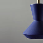 Bobbie Rod Pendant shown in Cobalt Blue Glaze Ceramic with a Brass Metal finish