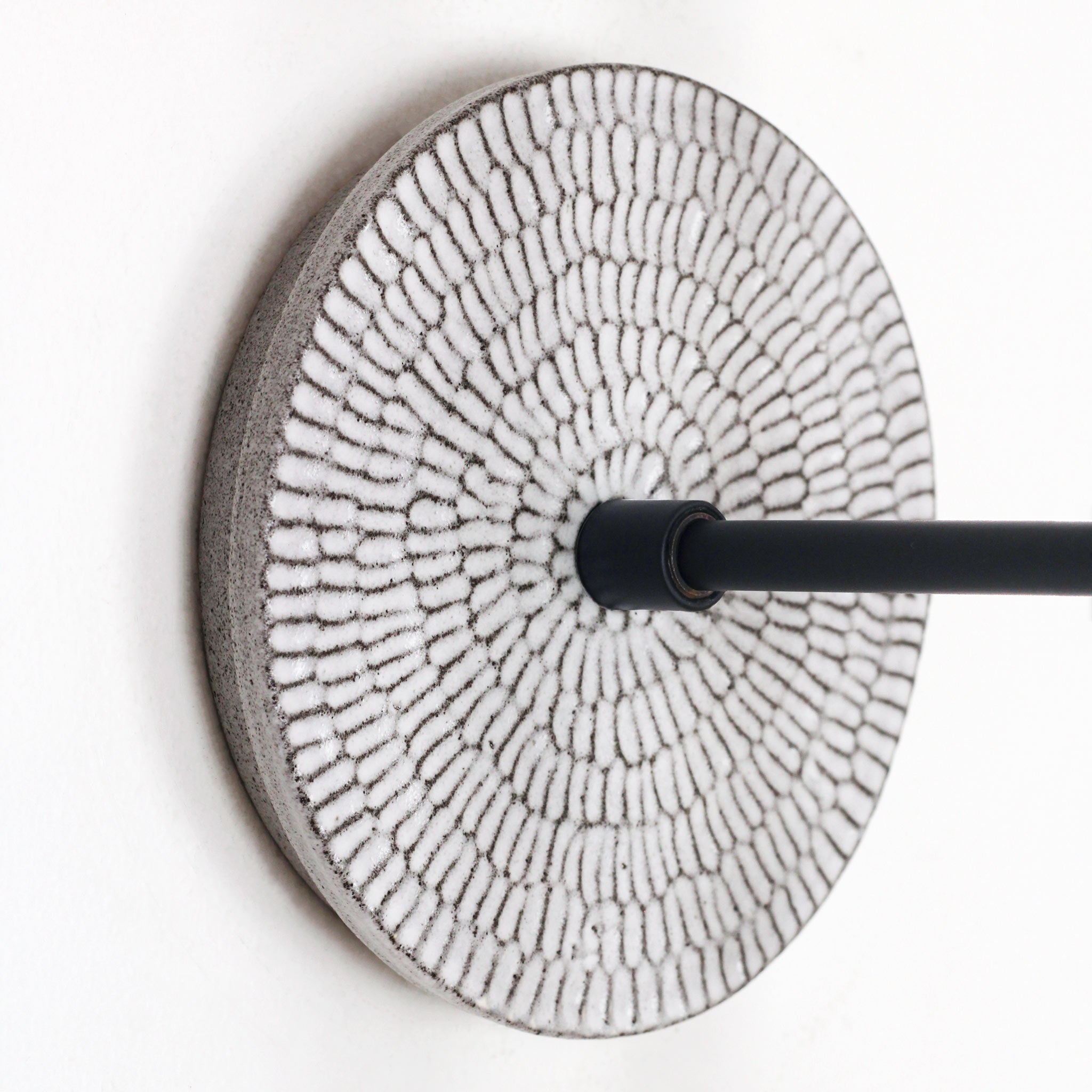 Sunflower canopy pattern shown in Brownstone White Ceramic with a Matte Black arm